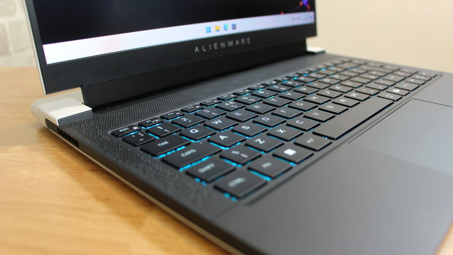 Alienware x14 laptop open, close up view of illuminated keyboard