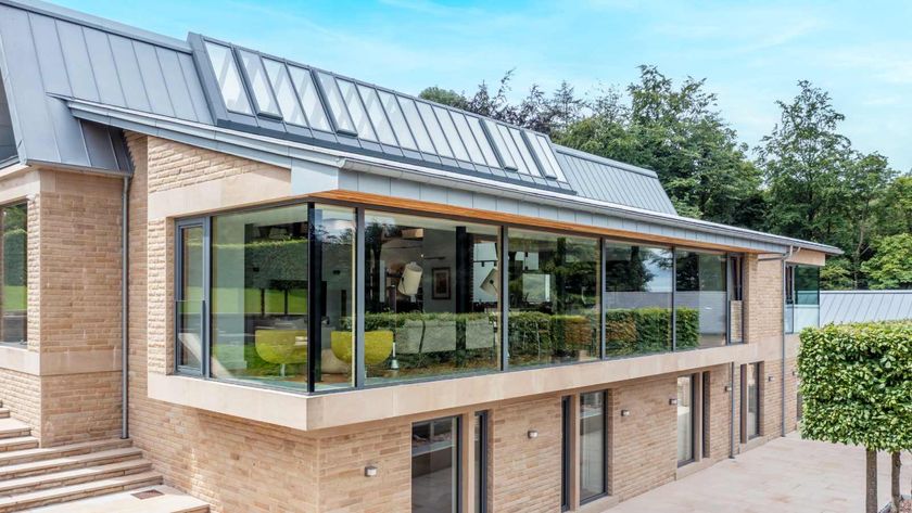 A contemporary Passivhaus clad in brick with a zinc roof with solar panels. The property, which is in the UK, features triple glazing from Internorm