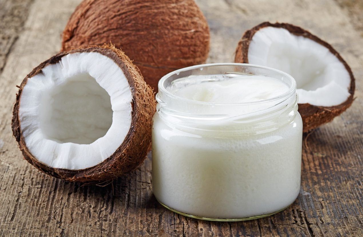 Coconuts Next To Jar Of Coconut Oil