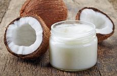 Coconuts Next To Jar Of Coconut Oil