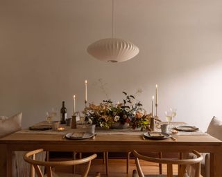 Minimalist Thanksgiving decor ideas, simple tablescape with candles, tableware and flowers and foliage