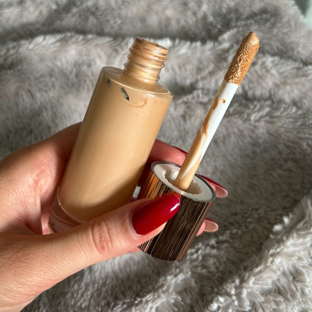 Image of Charlotte Tilbury Hollywood Flawless Filter open in hand with red nails
