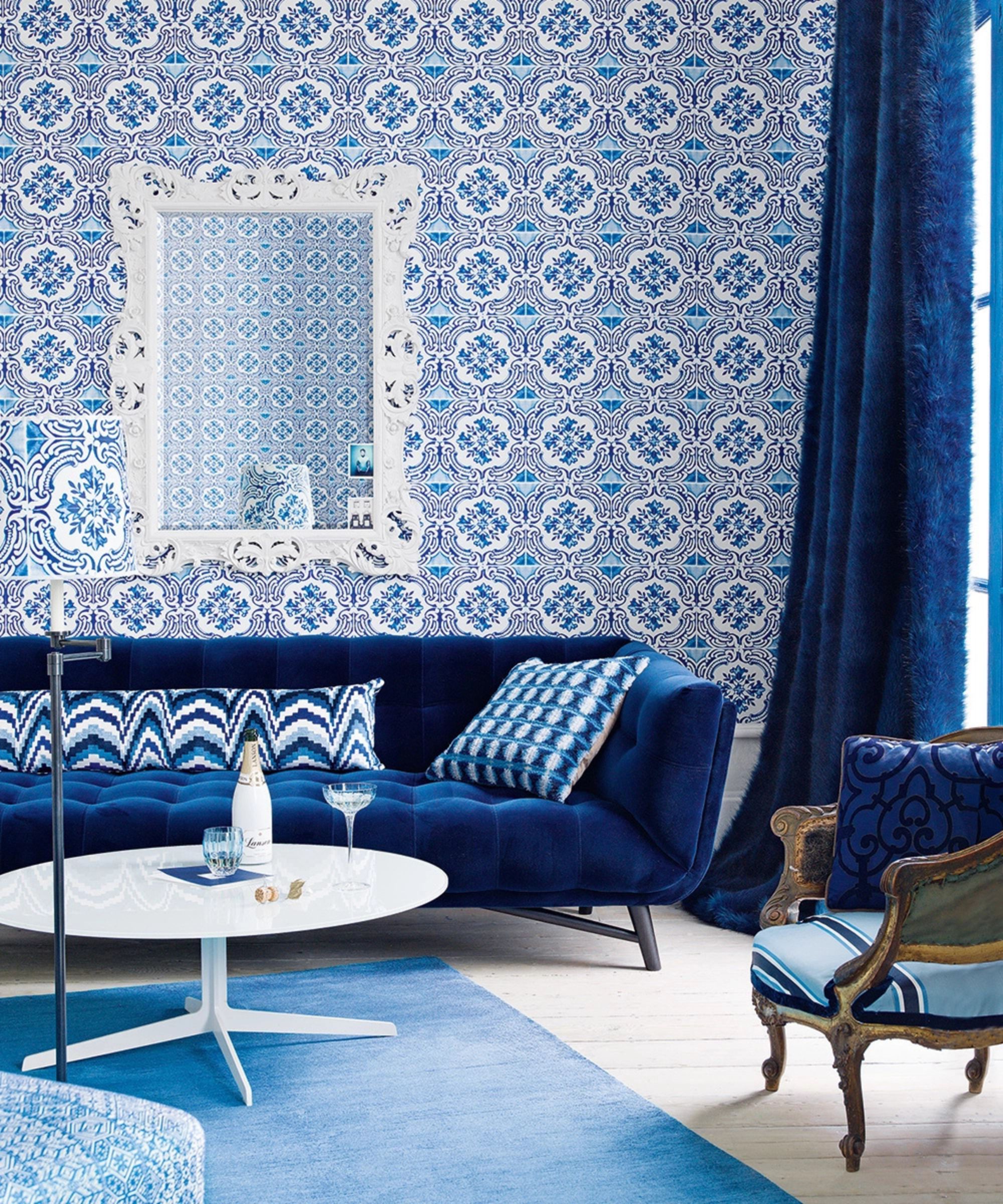 a cobalt blue living room with blue sofas, curtains and walls