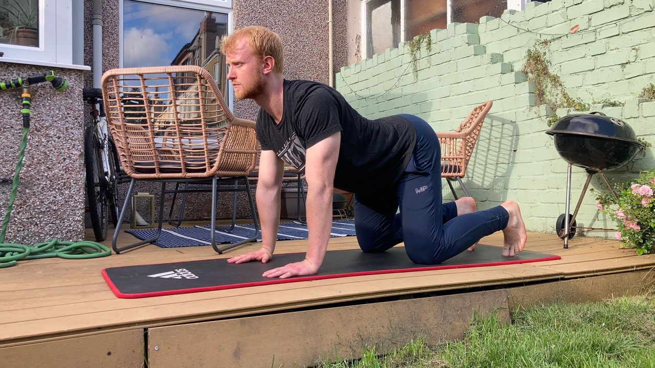 Fit&amp;Well writer Harry Bullmore performing the cat-cow stretch