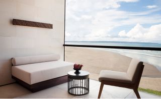 An image of a guest room balcony with a view of the sea