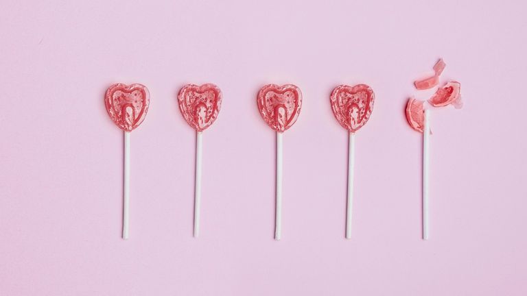 heart shaped lollypops in pink background