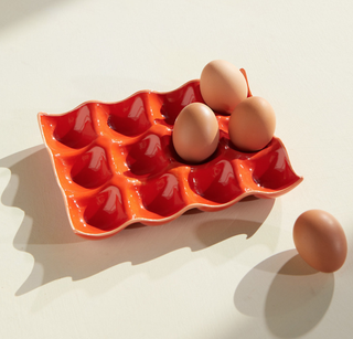orange ceramic tray with ridges to fit eggs inside