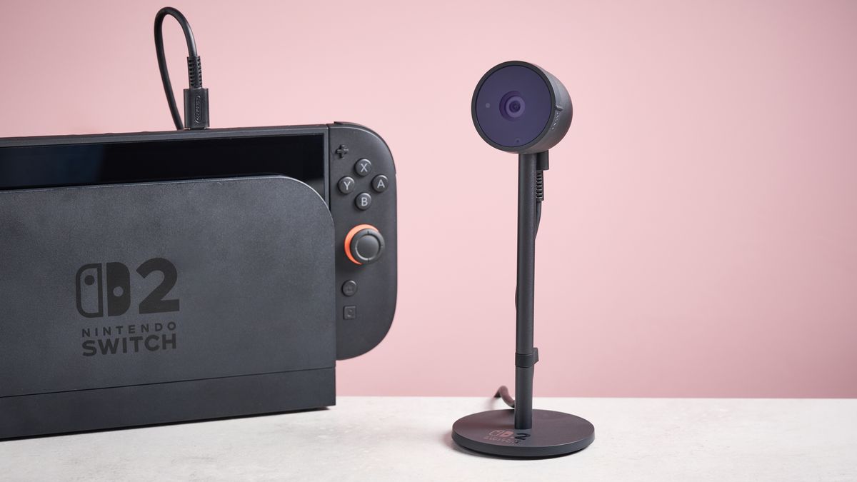 粉色背景中 Switch 2 控制台旁邊的 Nintendo Switch 2 攝像頭