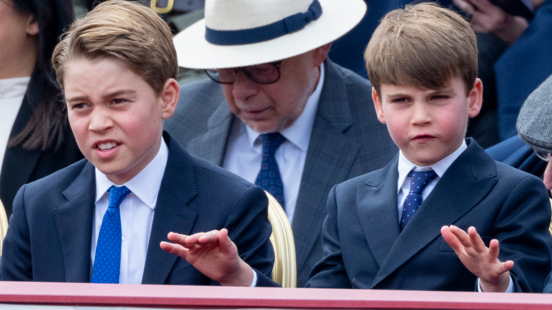 Prince George and Prince Louis sitting at the VE Day 80th parade