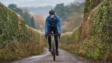 Image shows a rider cycling outdoors