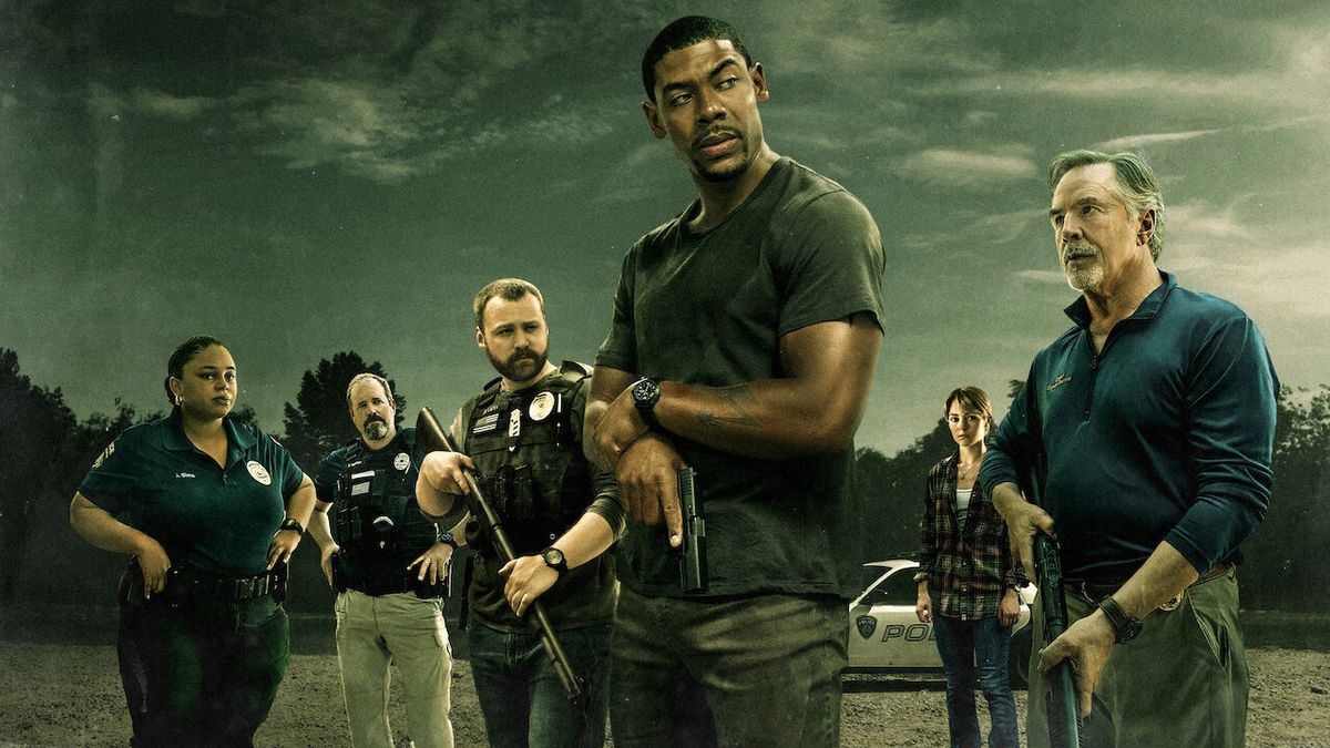 Promotional art for the film &#039;Rebel Ridge&#039; which shows the lead character holding a pistol and surrounded by armed law enforcement officers