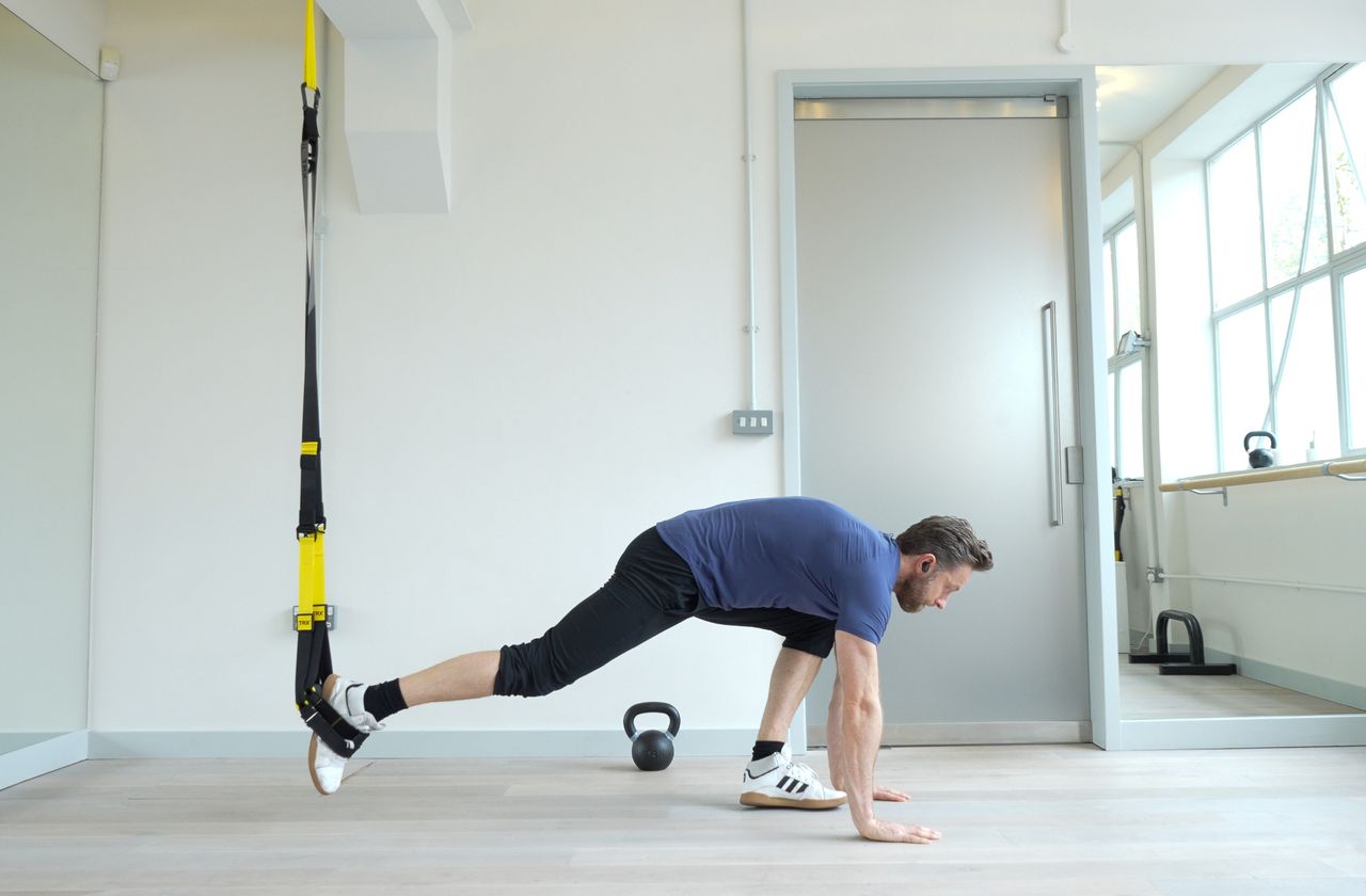 Niko Algieri demonstrates one position of the TRX burpee