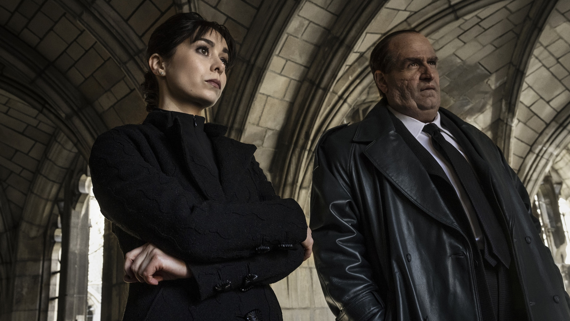 Sofia Falcone and Oz Cobb stand in a cemetery building in The Penguin