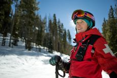 Strong female ski patrol smiling on a work day.