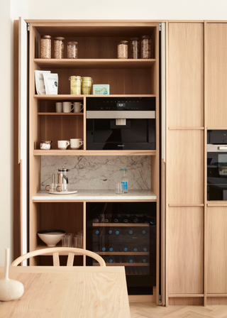 A llight oak double door breakfast bar with ample storage