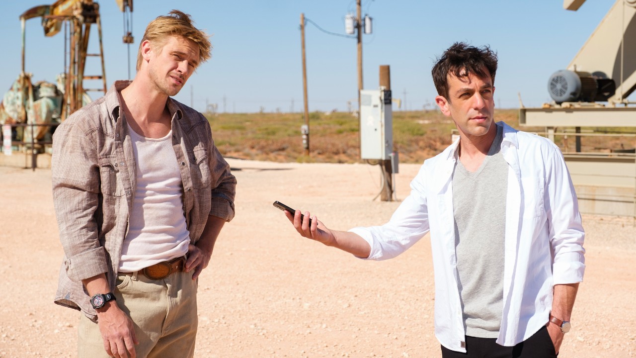 Boyd Holbrook standing and B.J. Novak holding up his phone to record what Holbrook is saying.