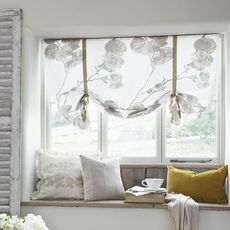 room with white wall and glass window with blinds