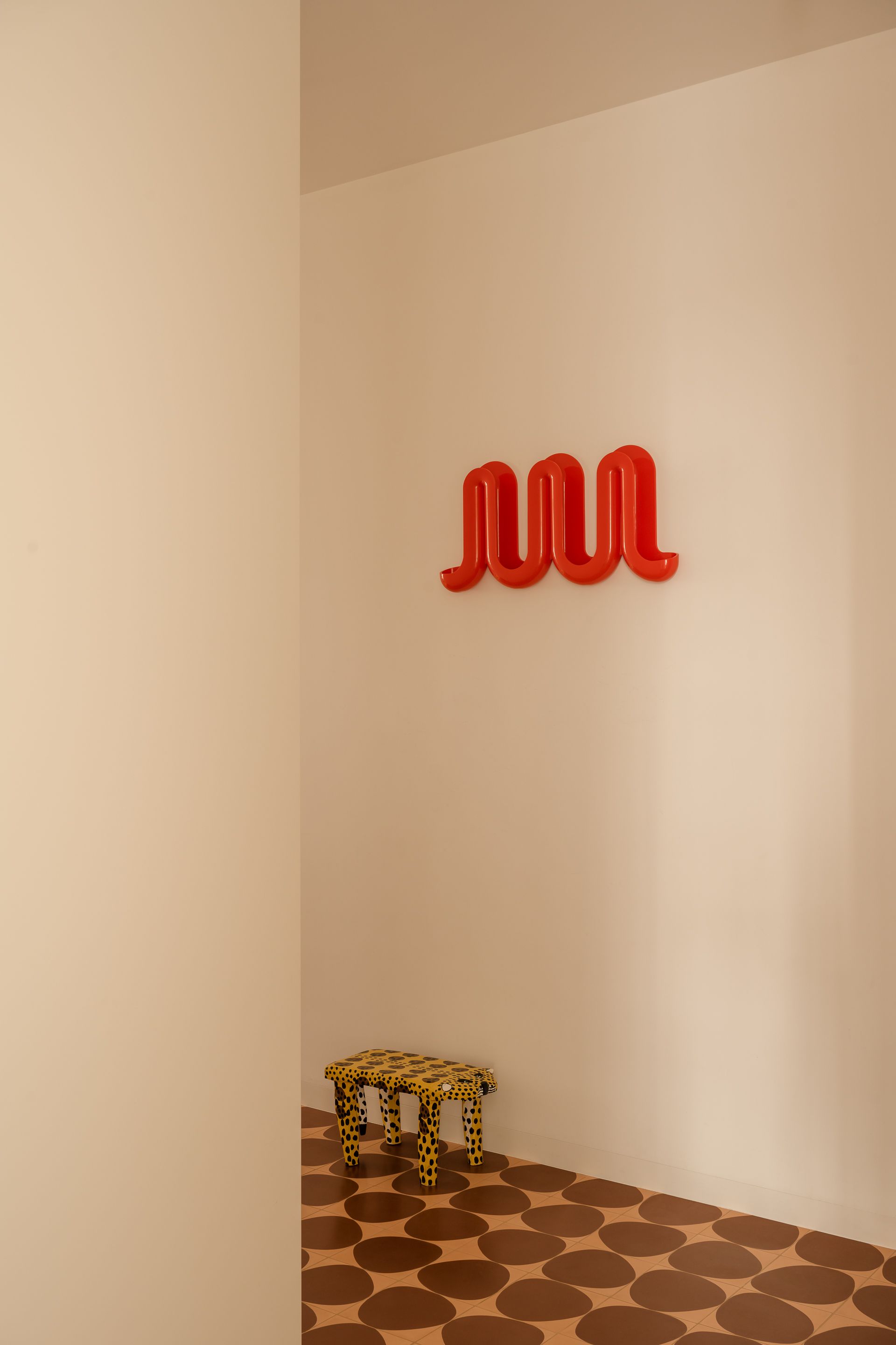 Red and leopard accents bring life to white walls