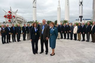 The 2013 class of U.S. Astronaut Hall of Fame inductees, Bonnie Dunbar (left), Curt Brown and Eileen Collins, are flanked by two dozen of their fellow Hall of Fame astronauts at the Kennedy Space Center Visitor Complex in Florida, April 20, 2013.