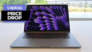 MacBook Air 15 in space gray colorway on a desk in front of a window