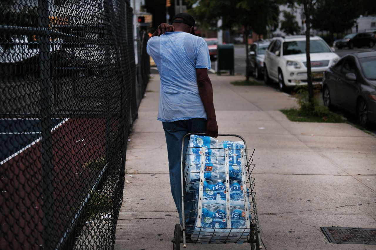 Newark, New Jersey, resident picking up bottled water.