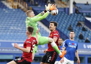 Everton goalkeeper Jordan Pickford gathers the ball while under pressure