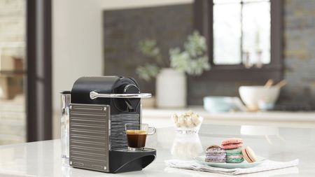 Nespresso Pixie coffee maker with macarons in kitchen