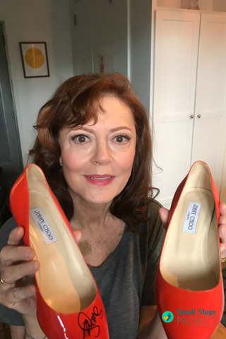 Susan Sarandon holding her shoes ahead of the auction.