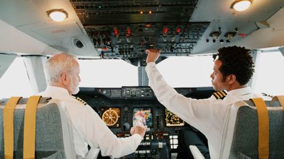 older pilot and younger pilot in cockpit of commercial plane