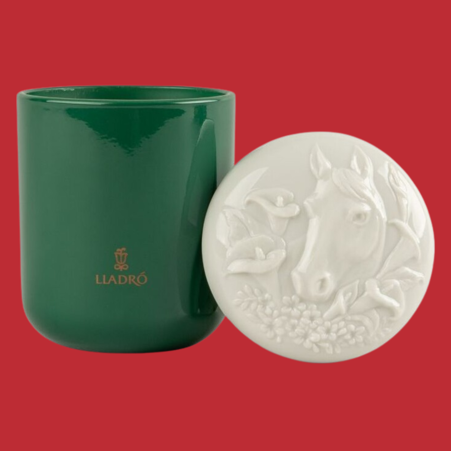 A scented candle in a green vessel by a horse-embossed lid