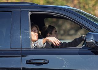 A photo of Jennifer Lopez flashing her cherry mocha manicure on a makeup-free car ride on Valentine's Day.