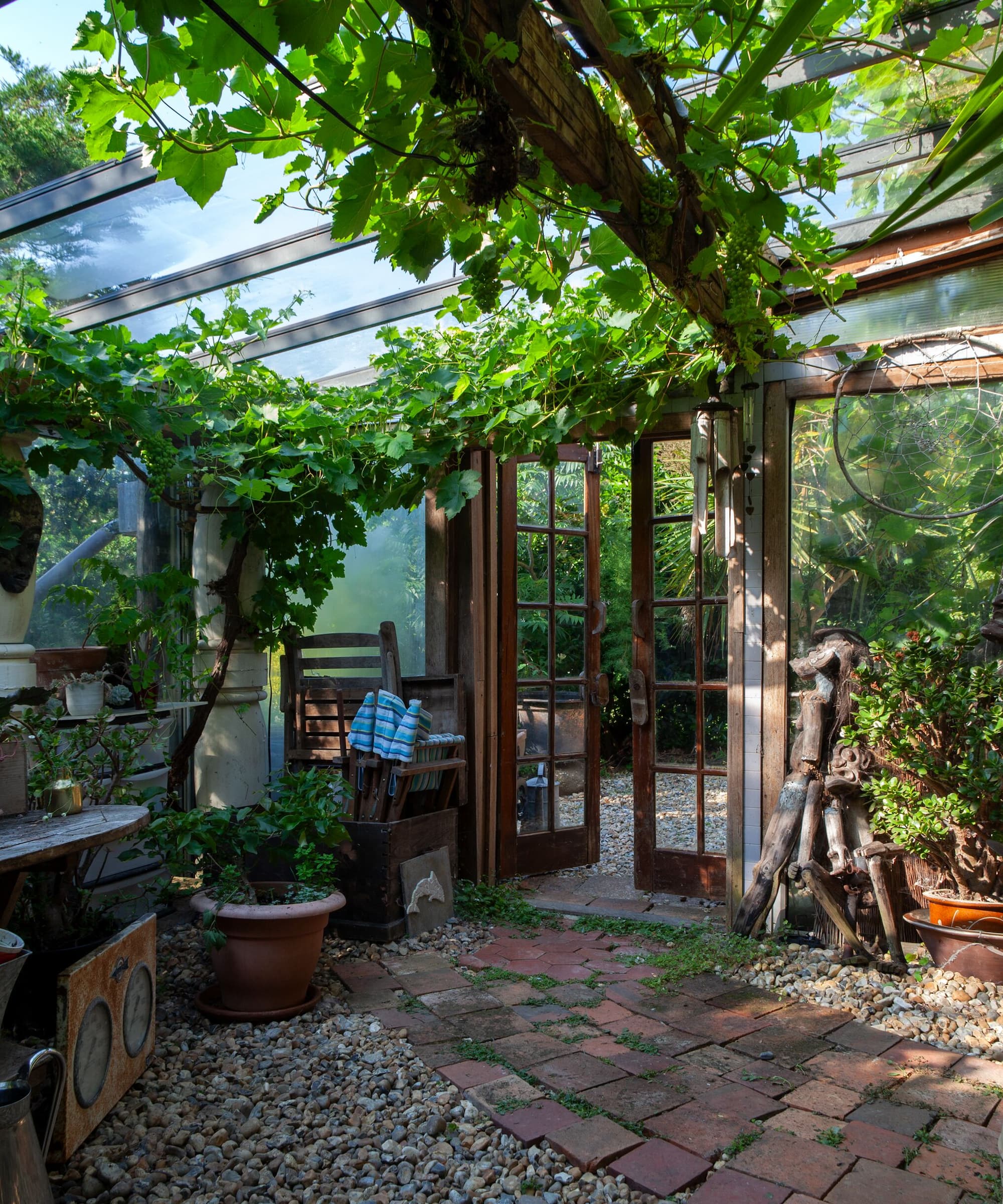 A garden room with a brick and gravelled floor