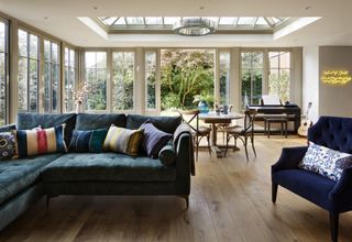 orangery ideas with velvet sofa, music space, and neon wall sign by Westbury Garden Rooms