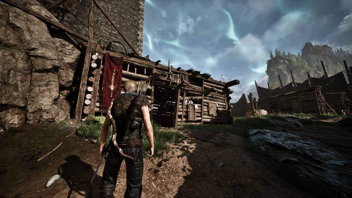 Gothic Remake Scatty's chest: A player stood outside Scatty's hut near the castle walls in the Old Camp, during the day, facing the building.