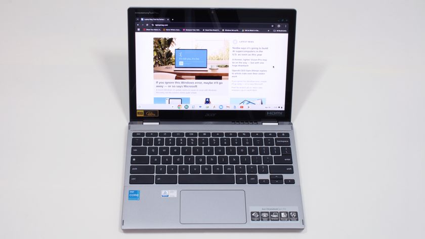 An open and powered on laptop against a white background, facing forward, with images and text displayed on a website on its screen