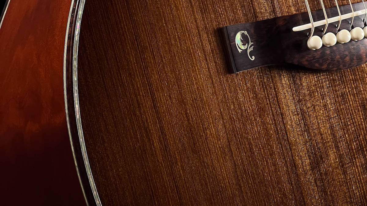 A close-up shot of the body of an acoustic guitar