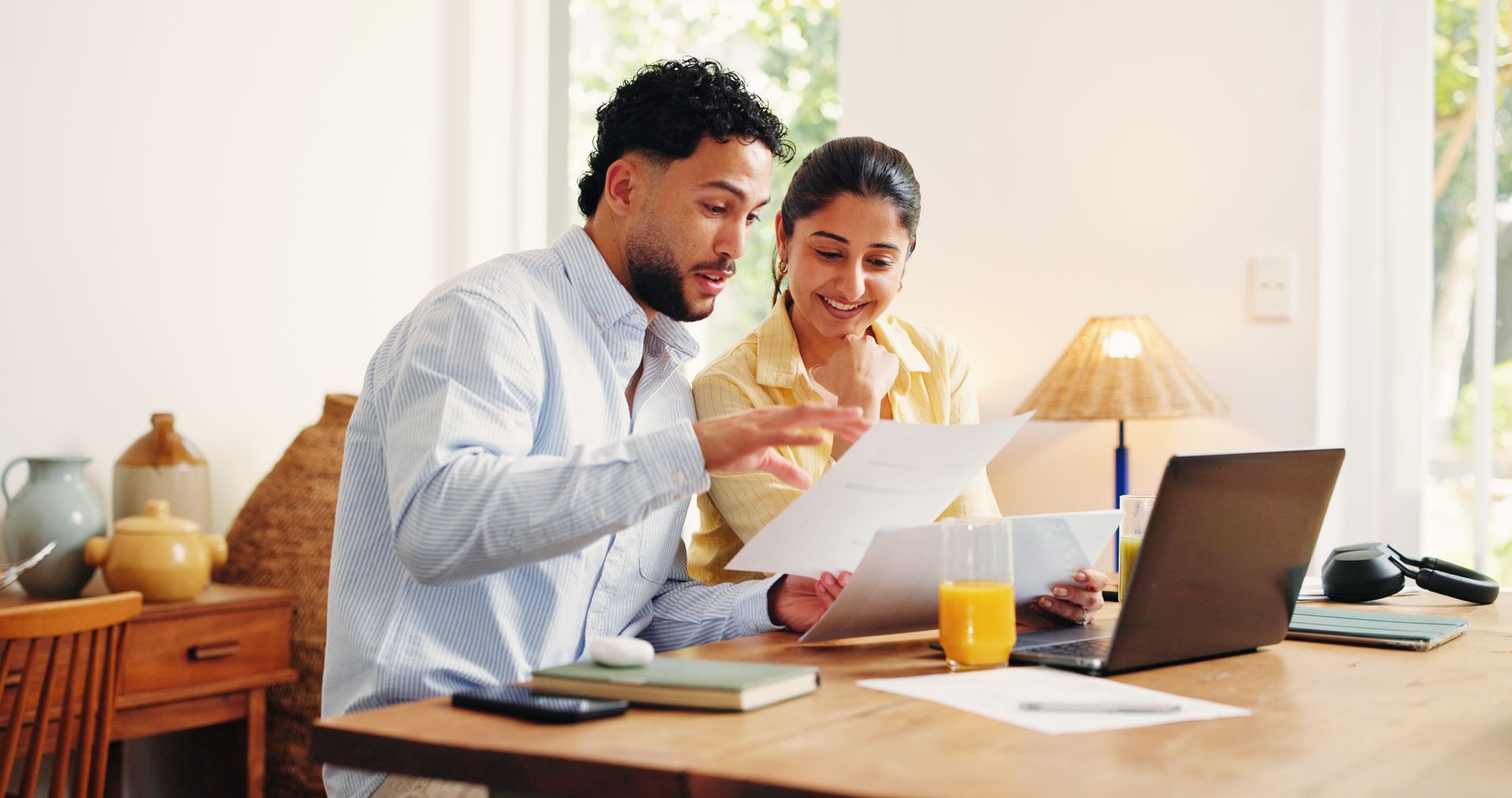 A couple sitting in front of a laptop, going over their personal finances.
