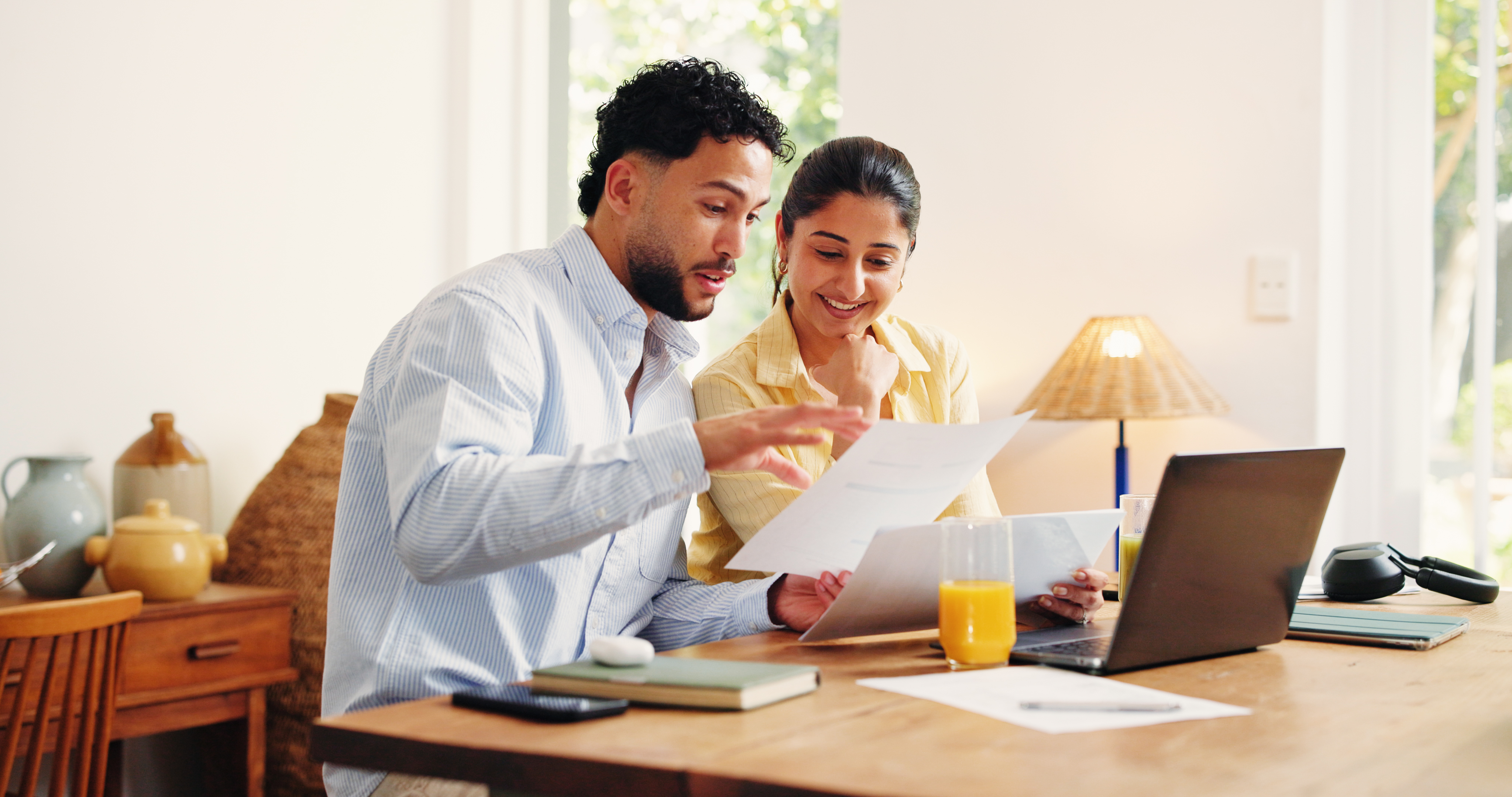 A couple sitting in front of a laptop, going over their personal finances.