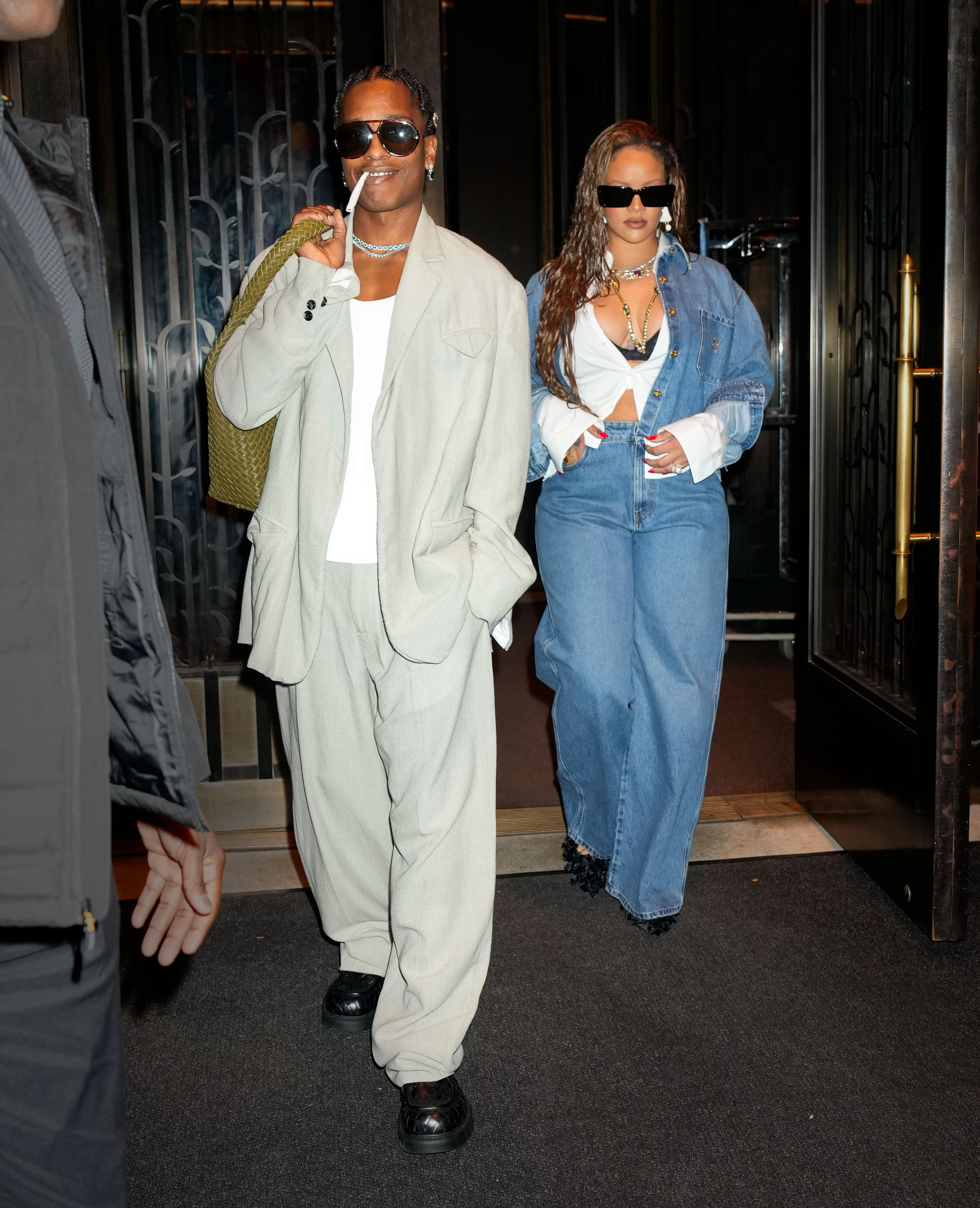 rihanna wearing denim jacket, and jeans and asap rocky wearing a blazer, trousers, and shoes