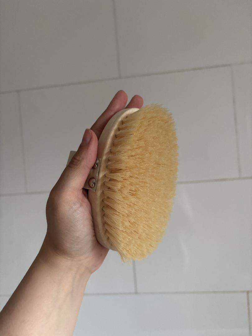 Mica Ricketts holding Aromatherapy Associates Polishing Body Brush