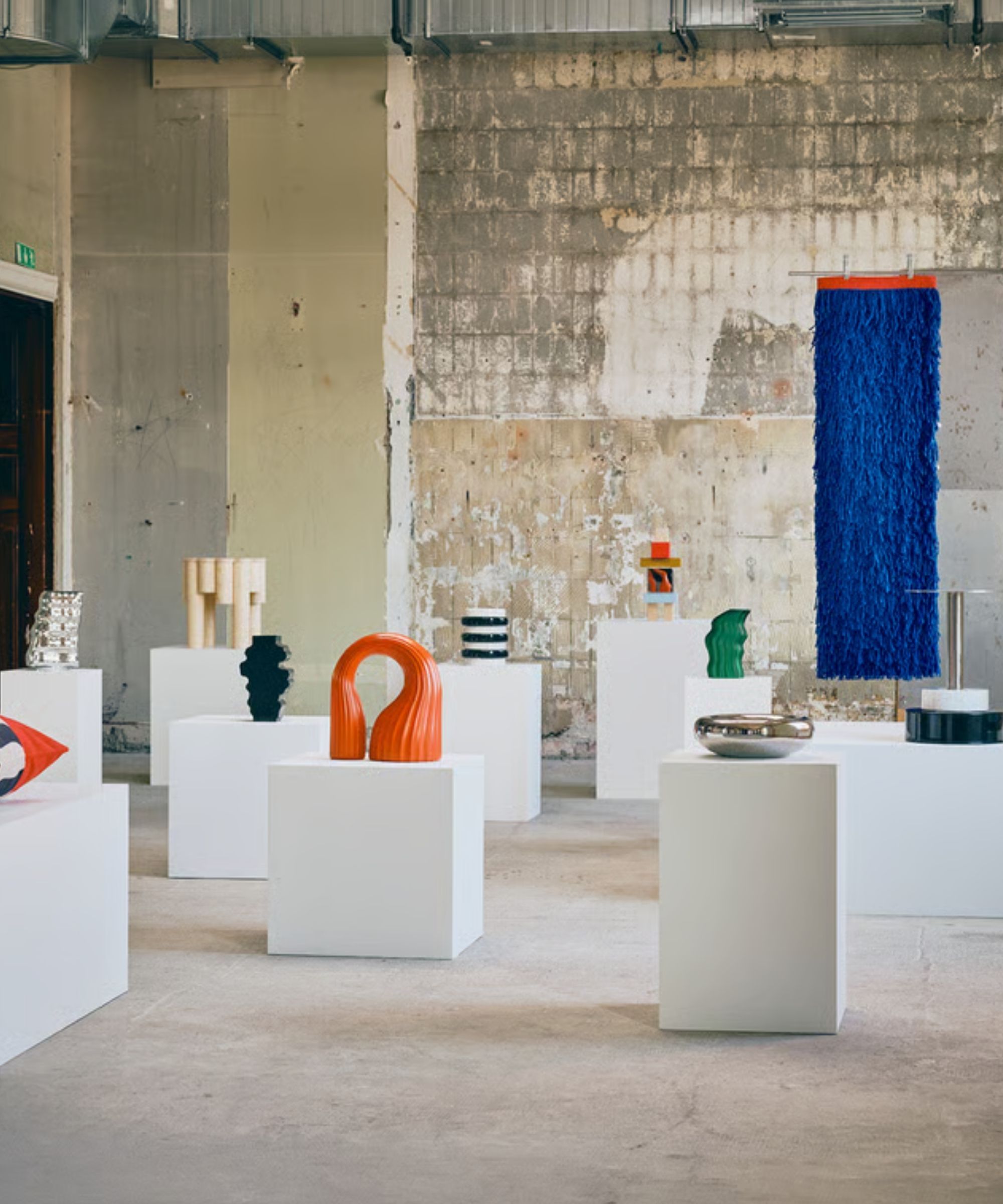 IKEA KONSTRUNDA collection on white plinths in a warehouse space