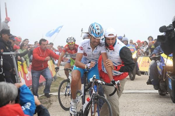 Ezequiel Mosquera is helped across the line after a vicious final climb.