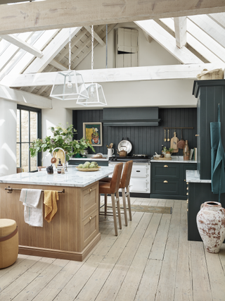 farmhouse style black kitchen with oak island