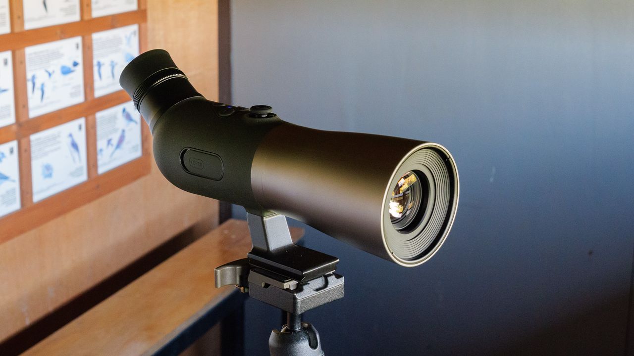 Bird spotting scope on tripod in bird watching hide
