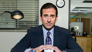 Michael Scott (Steve Carell) sitting at his desk in The Office