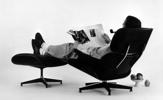 Charles Eames reclining on the plywood 'Ottoman' and 'Lounge' (for a 1956 advertisement photograph)