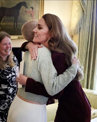 kate middleton hugs a cancer survivor wearing gold earrings from Cassandra Goad