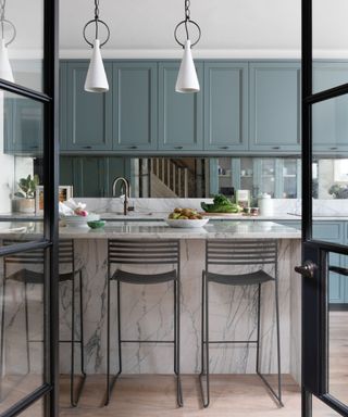 Light blue kitchen cabinets with chrome hardware
