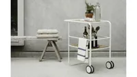 A white metal outdoor drinks trolley