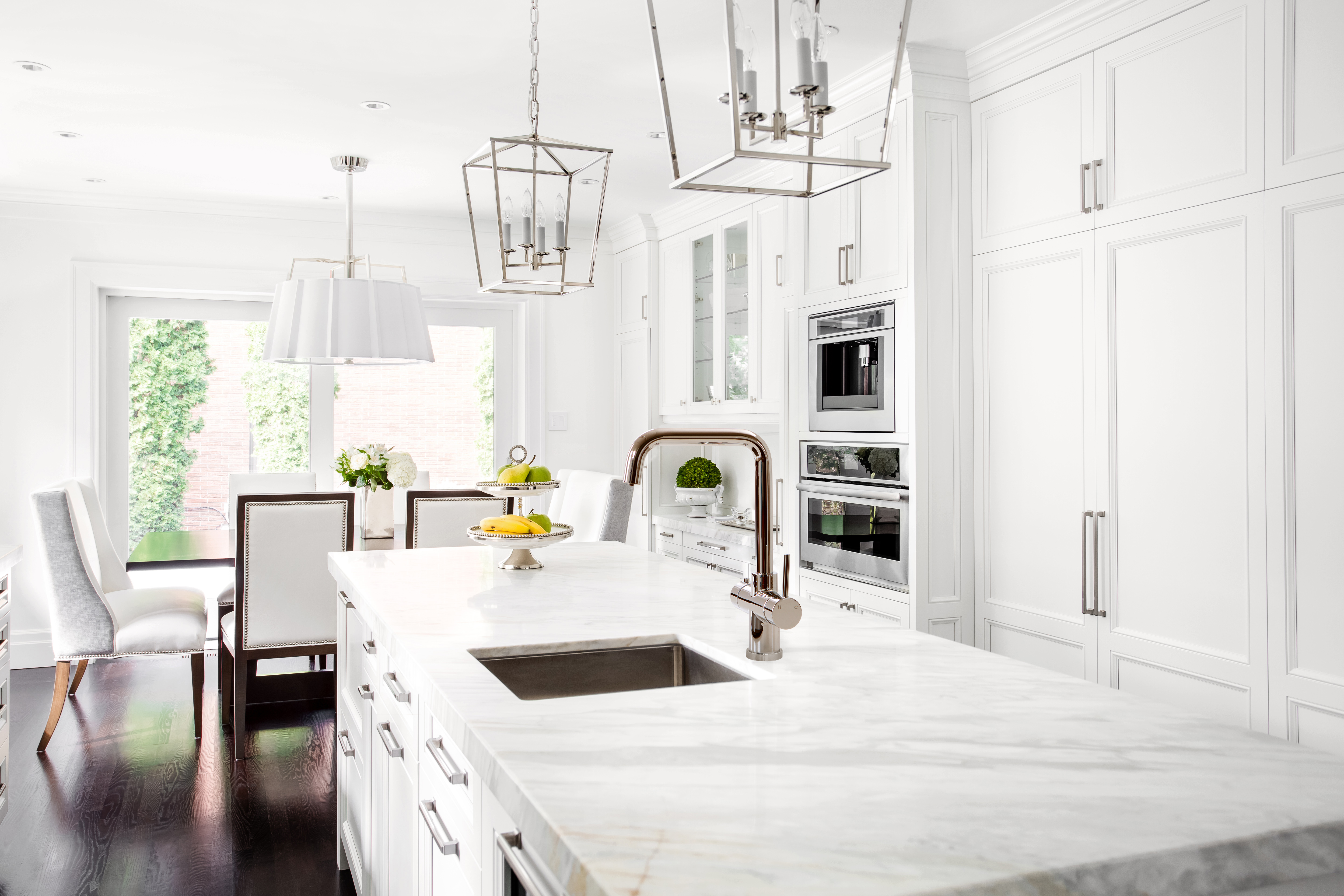 an all white open plan kitchen is a classic style